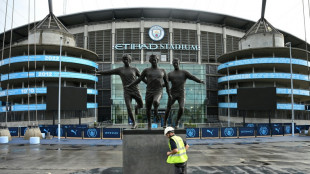 In Manchester, City fans 'devastated' while rival fans call for relegation