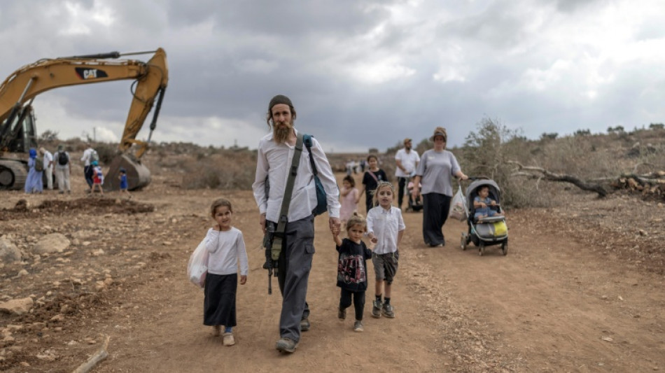 Israelis march between once-closed West Bank settlements